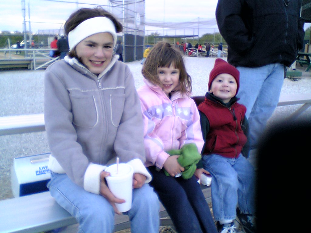 Emily, my best babysitter watching Kelly and Daniel at a cold ballgame.